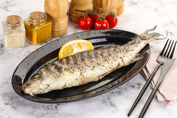 Grilled sea bass fish served lemon