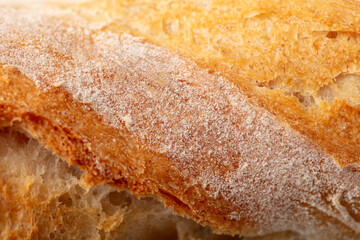Ruddy crust of bread as an abstract background. Texture