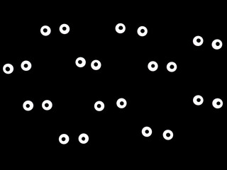 White sugar eyes on a black background. Eyes in the dark. Concept halloween.