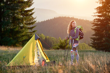 Woman traveller camping in mountains. Slim woman traveling, hiking outdoors. Beautiful, sporty...