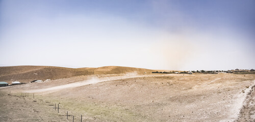 A dust whirlwind turns into a tornado in a desert area in Tajikistan, a wind tornado