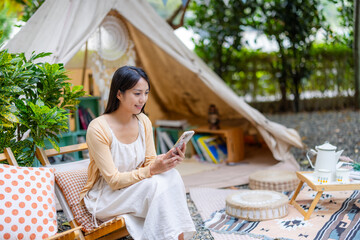 Woman use mobile phone in the camp site