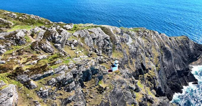Ireland Epic locations drone circling sheep&rsquo;s Head Lighthouse on rocky outcrop in Bantry Bay in West Cork on the Wild Atlantic Way tourist destination and magnificent wild location