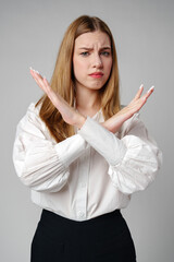 Young Woman Making X Sign With Arms to Express Prohibition or Disagreement