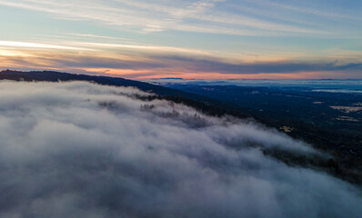 Sea of clouds around mountain peaks