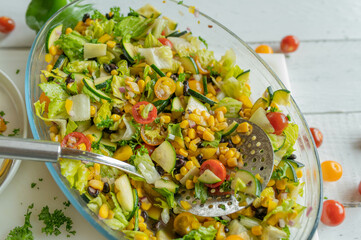 Homemade mexican salad with black beans and vegetables in a bowl
