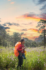 Hikers backpacks standing on top of a mountain and enjoying nature view