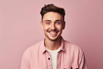 Fototapeta premium A man with a pink shirt and white shirt is smiling