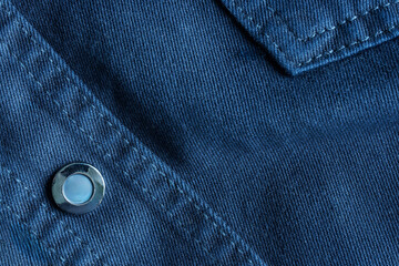 Abstract blue denim background with button fastening and decorative seams. Thread stitches. Photo....