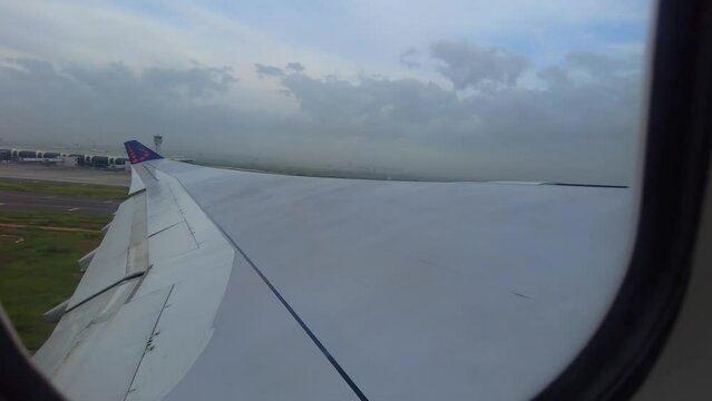 View of Blaise Diagne International airport terminal aerodrome through window of airplane taking off in Senegal