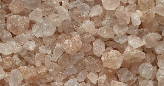 Pink coarse grain salt. Iron-rich European rock salt similar to Himalayan salt. Rotation around the center point.