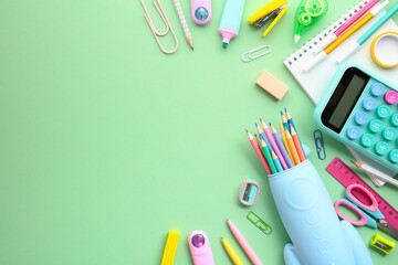 Back to school concept. School and office supplies on a vivid green background, ideal for...