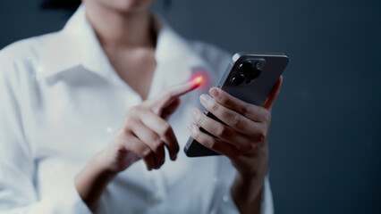  close-up of a woman's hand tapping on the screen of a mobile phone.