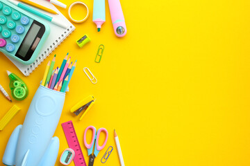 Bright Back-to-School Supplies on Yellow Background. Colorful assortment of educational tools,...