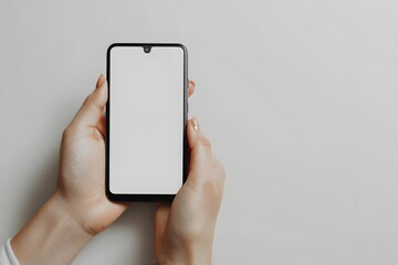 A person holding a smartphone with a blank screen