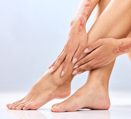 Woman, legs and hands with depilation in skincare, grooming or hair removal waxing on a blue studio...
