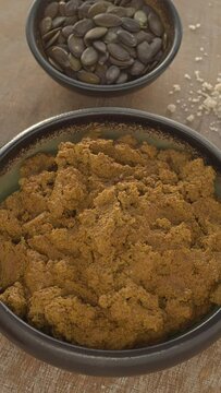 Mexican sauce Pipian Tlatonile. The sauce's main ingredients are sesame seeds, pumpkin seeds, dried chilies, olive oil, and salt. Table spin. Vertical video.