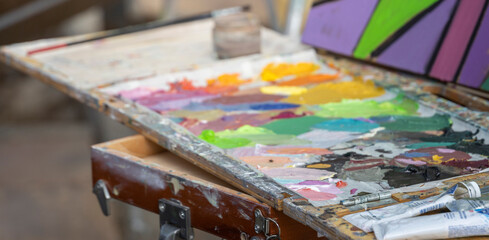 A vibrant artist's palette with an array of oil and acrylic paints, showcasing the creative process...