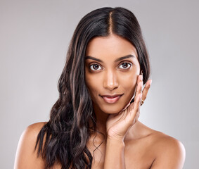 Portrait, skincare and beauty of Indian woman in studio for hair care, health or shine isolated on...