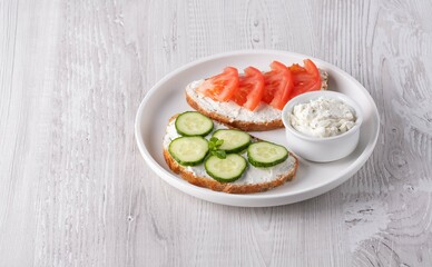 Healthy sandwiches with white cottage cheese, cucumber and tomato, with copy space for text