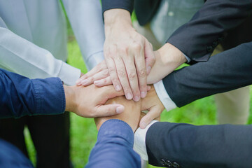 Business team unites, hands grouped in a powerful circle, embodying cooperation and strength in a...