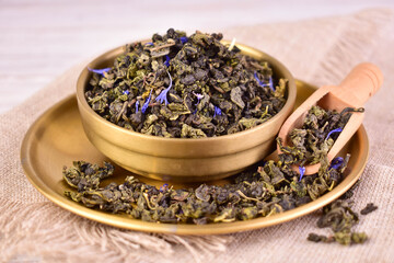 Green tea in a metal bowl. Close-up.
