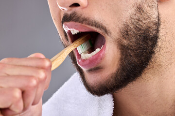 Close up, man and toothbrush in studio background for oral hygiene, cleaning mouth and medical...
