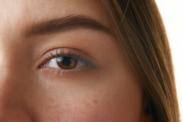 Close-up photo of woman's eye, highlighting well-defined eyebrow, long eyelashes, and smooth skin....