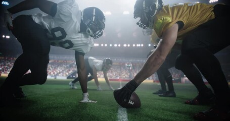 Gridiron Football Line of Scrimmage Standoff Between Two Diverse Teams Under Stadium Lights. Intense Moment of the Start of the Professional American Football Game, Players in Action During a Match