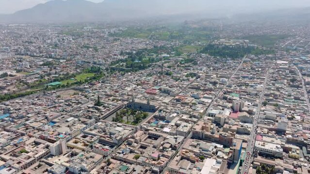 Enjoy a stunning aerial view of Arequipa from 500 meters high, exploring the city until reaching the majestic square and its cathedral in an exciting downward pan