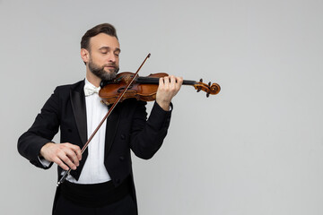 Handsome man artist playing violin