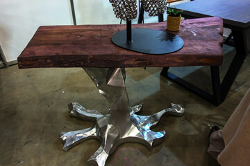 Decorative silver metal coffee table leg in the shape of a tree root.
