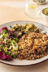 Delicious healthy breakfasts, buckwheat porridge with mixed salad with seeds and fried mushrooms with eggs, top view of plates with food
