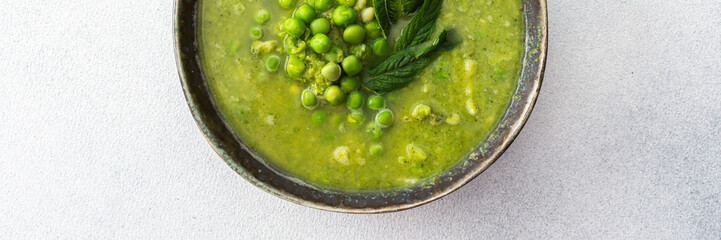 Creamy broccoli and green pea soup with mint, delicious healthy lunch, banner