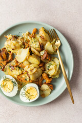 Delicious hearty dinners or lunches, fried young potatoes with forest mushrooms Chanterelles with dill, boiled eggs, seasonal food