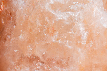 Himalayan salt texture, macro, copy space. Natural salt background. Himalayan coral pink rock salt, closeup.