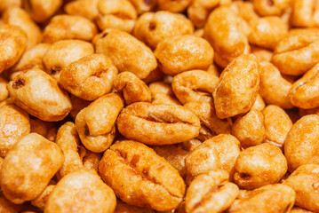 caramel wheat dry cereal for breakfast macro closeup background.