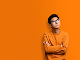 Orange background sad asian man realistic person portrait of young teenage beautiful bad mood expression boy Isolated on Background depression anxiety fear burn out 