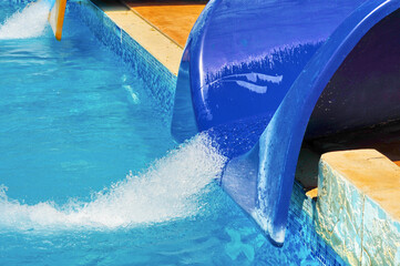 blue plastic water slides with splash in summer amusement aqua park