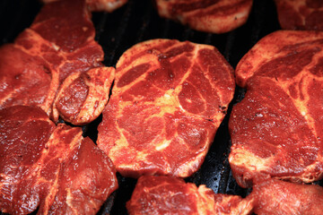 View of the seasoned pork on the grill