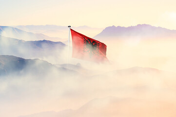 Albania flag disappears in beautiful clouds with fog.