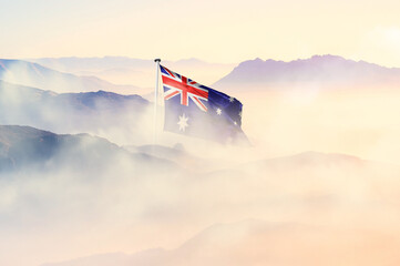 Australia flag disappears in beautiful clouds with fog.