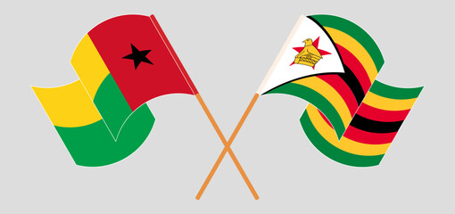 Crossed and waving flags of Guinea-Bissau and Zimbabwe