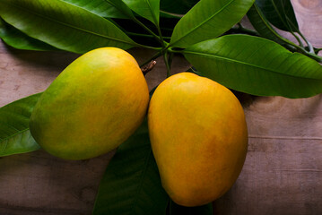 Fresh Mango tropical fruit with green leaf, Ripe mango in grass.