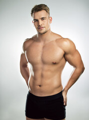 Obraz premium Muscle, strong and body of man for fitness, health and exercise for training goal on white studio background. Portrait, sports and bodybuilder model with sexy, young and healthy abs from sports