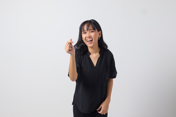 Portrait of attractive Asian woman in casual shirt making korean heart sign means love to you....