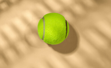 Tennis ball on sandy surface