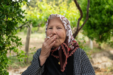Old woman smoking a cigarette.