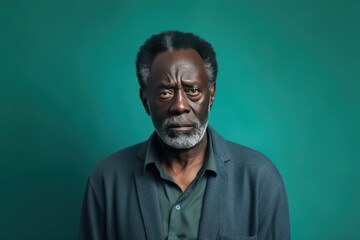 Teal background sad black American independent powerful man. Portrait of older mid-aged person beautiful bad mood expression isolated on background racism skin color depression 