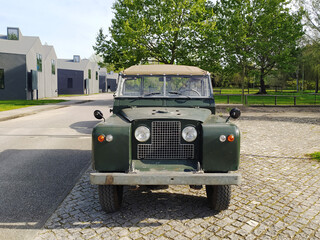 Green classic old SUV. Vintage car against the backdrop of nature. Legendary transport vehicle.